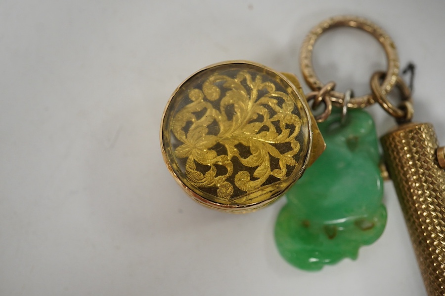 An unmarked yellow metal vinaigrette, 18mm, together with a yellow metal overlaid combination propelling pencil/penknife and a carved jade fob. Condition - fair to good.